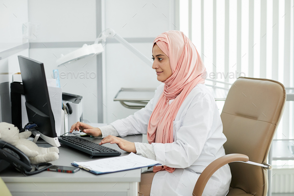Middle-Eastern female Doctor at desk - Stock Photo - Images