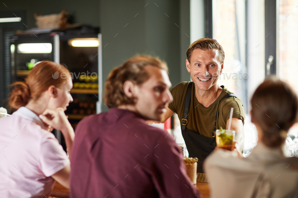 Cheerful Man Enjoying Lunch with Friends in Cafe - Stock Photo - Images