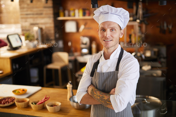 Tattooed Chef Posing in Kitchen - Stock Photo - Images