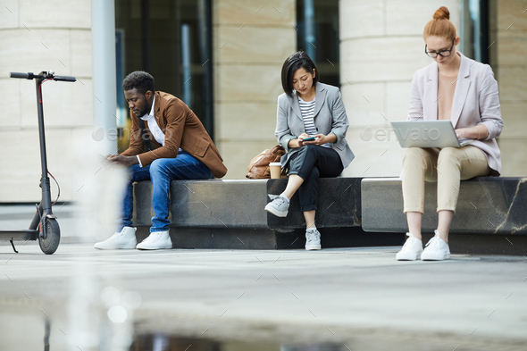 People Using Mobile Devices Outdoors - Stock Photo - Images