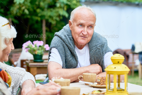 Senior Man Surrounded by Friends - Stock Photo - Images