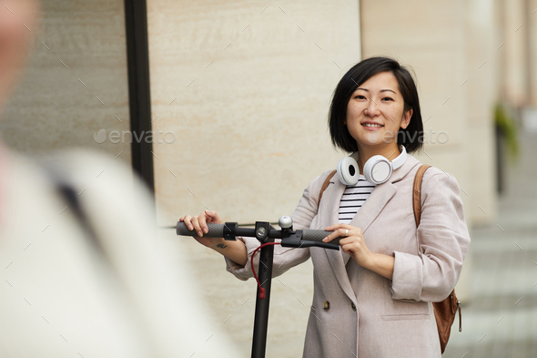 Modern Asian Woman Riding Scooter - Stock Photo - Images