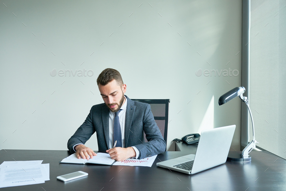 Bearded Entrepreneur Wrapped up in Work - Stock Photo - Images