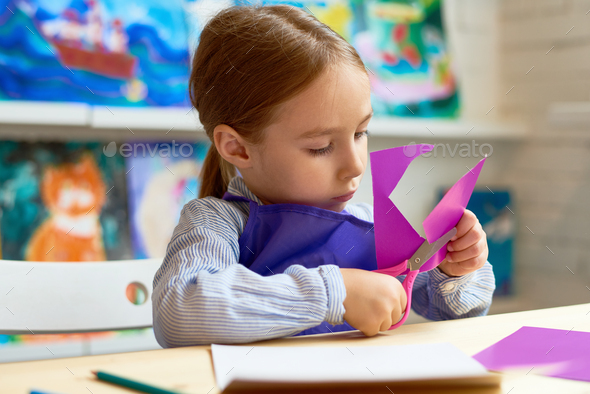 Cute Girl Cutting Out Paper Heart in Craft Class - Stock Photo - Images