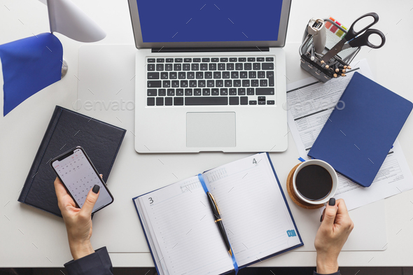 Nonstop working office woman with cup of coffee at her workplace ...