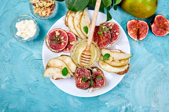 Bruschetta and Crostini with pear, ricotta cheese, honey, figs. - Stock Photo - Images