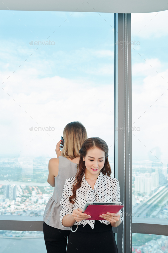 Young businesswoman reading financial report - Stock Photo - Images