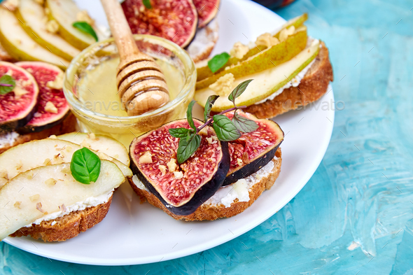 Bruschetta and Crostini with pear, ricotta cheese, honey, figs. - Stock Photo - Images