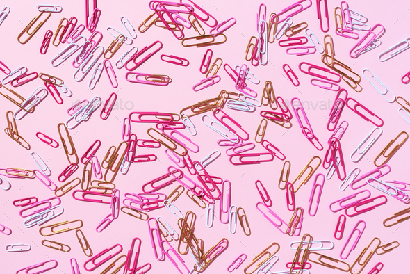 Colored paper clips on pastelion, office work - Stock Photo - Images