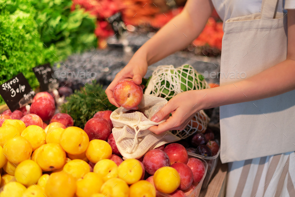 Zero waste, plastic free concept. Sustainable lifestyle. Woman chooses fruits and vegetables at