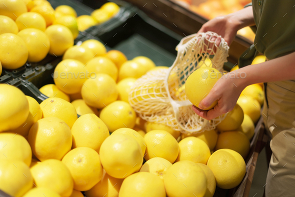 Zero waste, plastic free concept. Sustainable lifestyle. Woman chooses fruits and vegetables at