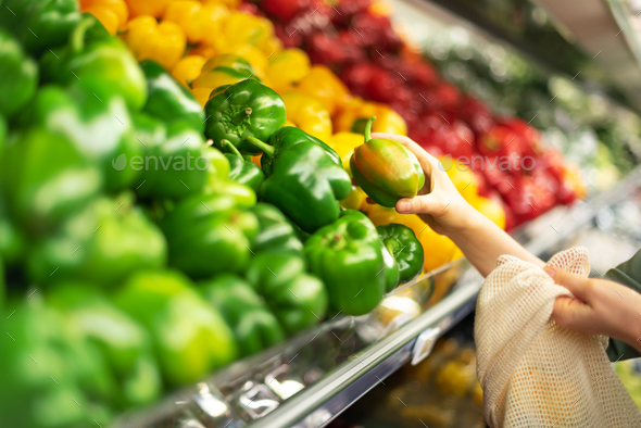 Zero waste, plastic free concept. Sustainable lifestyle. Woman chooses fruits and vegetables at