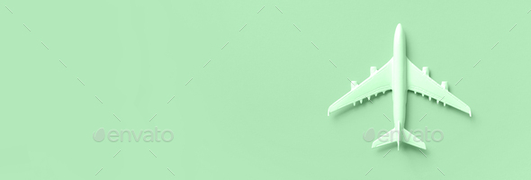 White plane, airplane on trendy mint color background with copy space. Top view, flat lay. Minimal - Stock Photo - Images