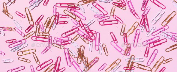 Pattern of multicolored paper clips on pink background. Back to school. Office, business, paperwork - Stock Photo - Images