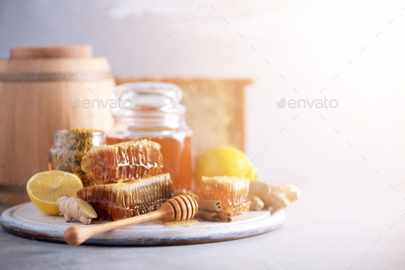 Ingredients for healthy hot drink. Lemon, ginger, mint, honey, apple and spices on grey background - Stock Photo - Images