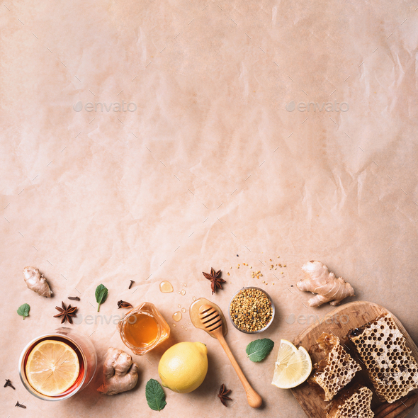 Autumn picnic. Herbal tea, honey and bee products, apple, lemon, calendula, spices on craft paper - Stock Photo - Images