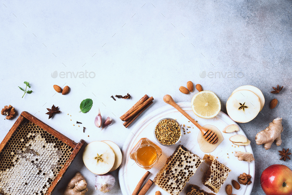 Ingredients for healthy hot drink. Lemon, ginger, mint, honey, apple and spices on grey concrete - Stock Photo - Images