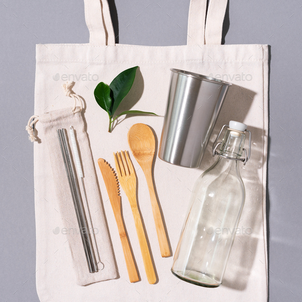 Fabric bags, glass jars, metal straws, bamboo cutlery on grey background with copy space. Eco - Stock Photo - Images
