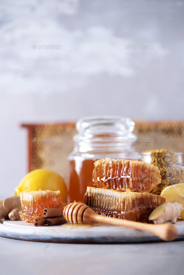 Ingredients for healthy hot drink. Lemon, ginger, mint, honey, apple and spices on grey background - Stock Photo - Images