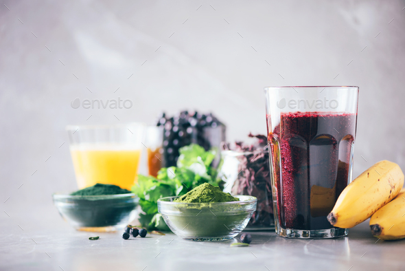 Healthy eating, alkaline diet, vegan concept. Blueberries, bilberry, barley grass juice, spirulina - Stock Photo - Images