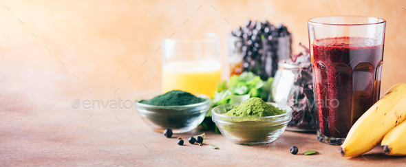 Healthy eating, alkaline diet, vegan concept. Blueberries, bilberry, barley grass, spirulina powder - Stock Photo - Images
