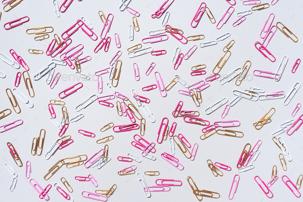 Pattern of multicolored paper clips on grey background. Back to school. Office, business, paperwork - Stock Photo - Images