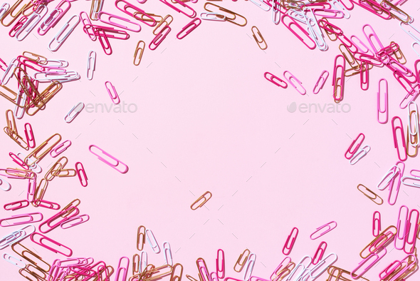 Frame of multicolored paper clips on pink background. Back to school. Office, business, paperwork - Stock Photo - Images