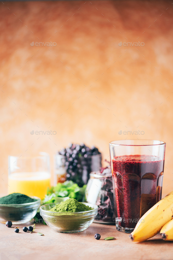 Healthy eating, alkaline diet, vegan concept. Blueberries, bilberry, barley grass, spirulina powder - Stock Photo - Images