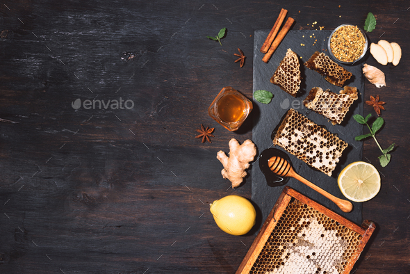 Ingredients for healthy hot drink. Lemon, ginger, mint, honey, apple and spices on black slate tray - Stock Photo - Images