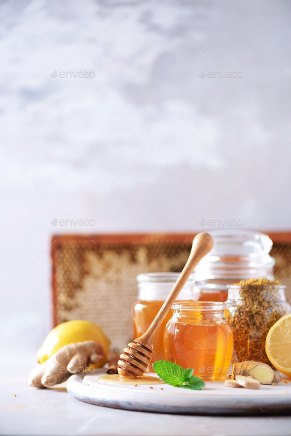 Ingredients for healthy hot drink. Lemon, ginger, mint, honey, apple and spices on grey background - Stock Photo - Images