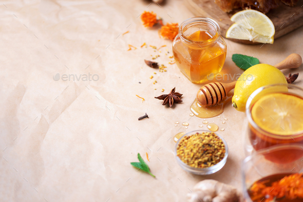 Autumn harvest concept. Set of honey and bee products, apple, lemon, spices on craft paper - Stock Photo - Images