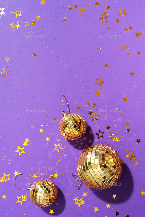 Creative Christmas concept. Shiny gold disco balls over red background.  Flat lay, top view. New year Stock Photo by jchizhe