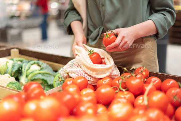 Zero waste, plastic free concept. Sustainable lifestyle. Woman chooses fruits and vegetables at