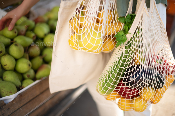 Zero waste, plastic free concept. Sustainable lifestyle. Woman chooses fruits and vegetables at