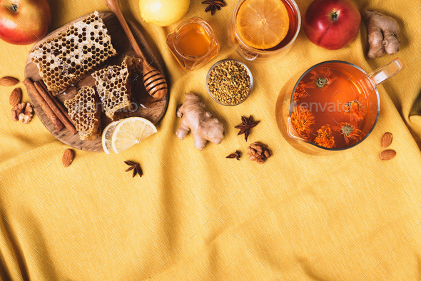 Autumn harvest concept. Set of honey and bee products, apple, lemon, calendula tea, spices on yellow - Stock Photo - Images