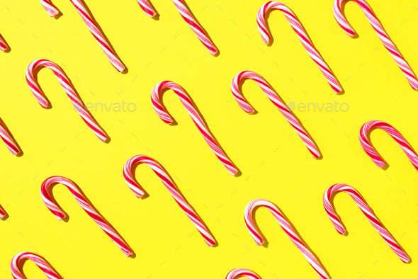Pattern of Christmas candy cane on yellow background. Top view. Flat lay. Creative minimal concept - Stock Photo - Images