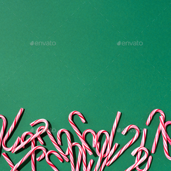 Christmas candy canes on green background. Top view. Flat lay. Creative minimal concept. Greeting - Stock Photo - Images