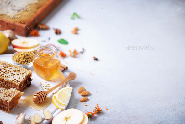 Ingredients for healthy hot drink. Lemon, ginger, mint, honey, apple and spices on grey concrete - Stock Photo - Images