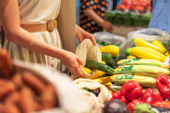 Zero waste, plastic free concept. Sustainable lifestyle. Woman chooses fruits and vegetables at