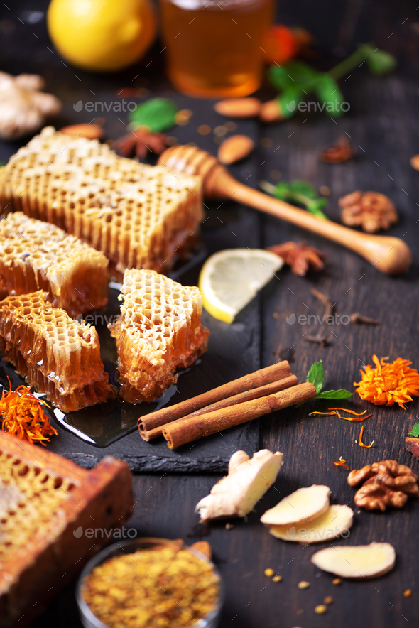 Autumn harvest concept. Set of honey and bee products, apple, lemon, spices on dark background