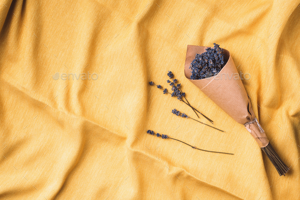 Dry lavender flowers on yellow fabric texture background. top view. Flat lay. Free space for text or - Stock Photo - Images