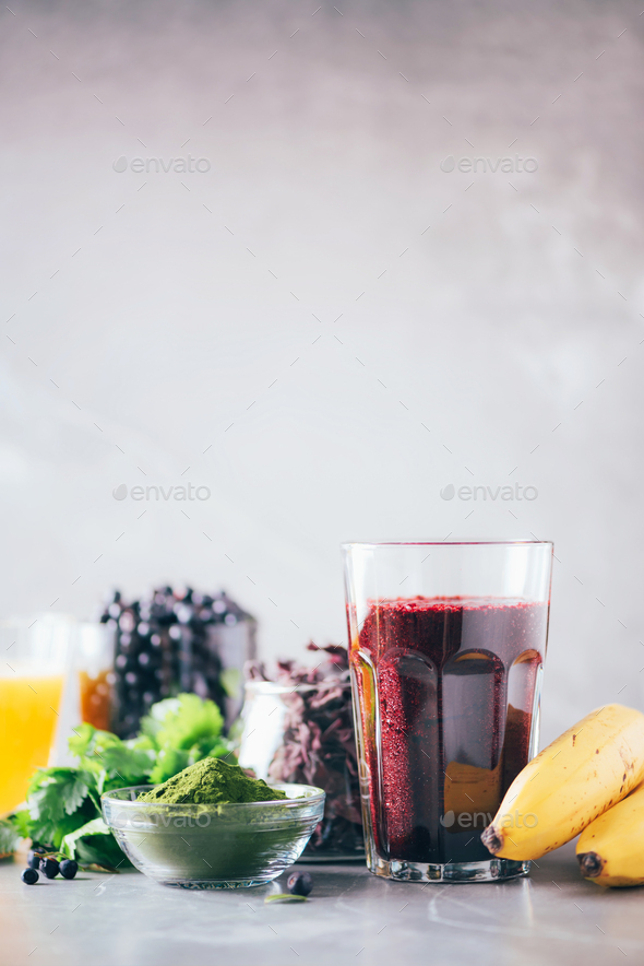 Fresh blueberries, bilberry, barley grass juice, spirulina, orange juice, dulse and cilantro on - Stock Photo - Images