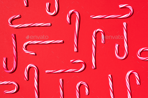 Christmas candy cane on red background. Top view. Flat lay. Creative minimal concept. Greeting card - Stock Photo - Images