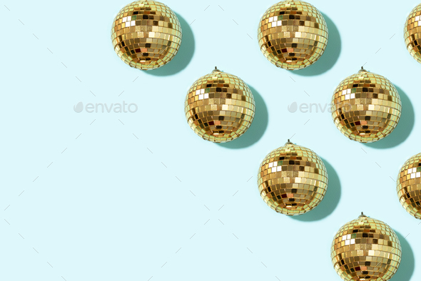 Christmas gold baubles organized on blue background. Top view. Flat lay. Creative New year pattern - Stock Photo - Images