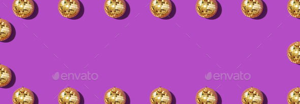 Creative Christmas pattern. Frame with shiny gold disco balls over violet background. Flat lay, top - Stock Photo - Images