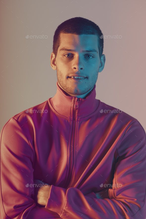 Studio close-up portrait of attractive male model. Color flash studio light - Stock Photo - Images