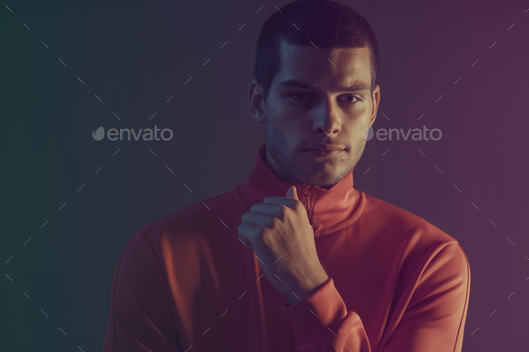 Studio close-up portrait of attractive male model. Color flash studio light - Stock Photo - Images
