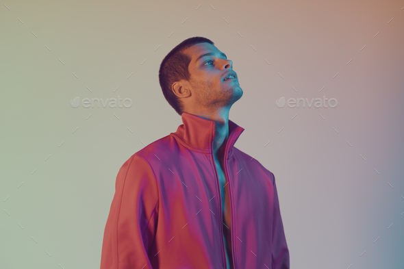 Studio close-up portrait of attractive male model. Color flash studio light - Stock Photo - Images