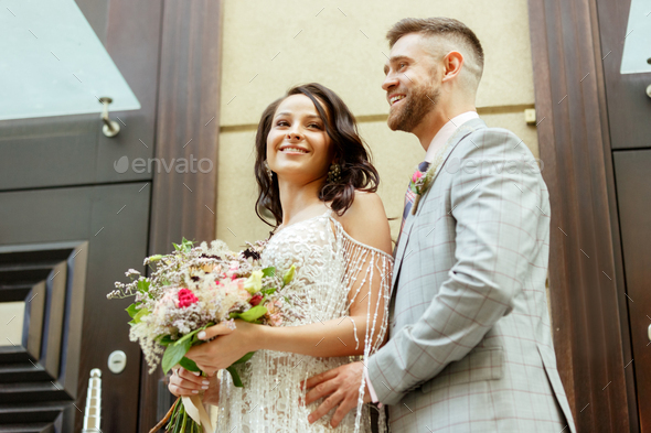 Caucasian romantic young couple celebrating their marriage in city - Stock Photo - Images