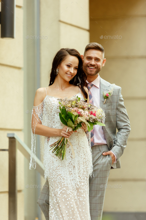 Caucasian romantic young couple celebrating their marriage in city - Stock Photo - Images